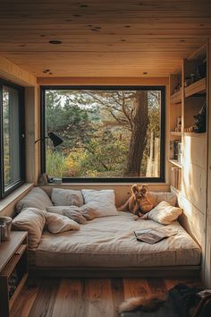 a dog sitting on a bed in front of a window