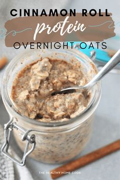 cinnamon roll protein overnight oats in a glass jar with a spoon on the side