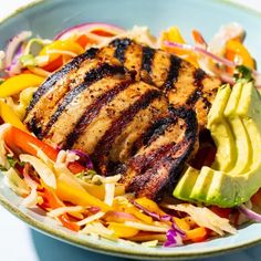 a salad with chicken and avocado in a bowl