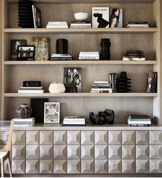 a book shelf with books and pictures on it