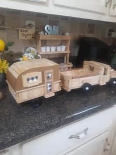 a wooden toy truck sitting on top of a kitchen counter