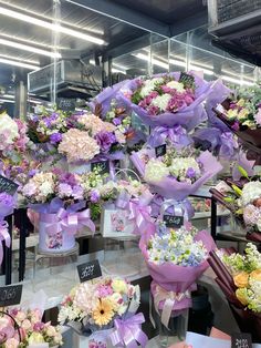 a bunch of flowers that are on display in a vases with ribbons around them