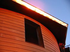 a man standing on top of a wooden building