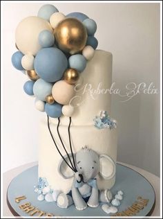 there is a cake decorated with balloons and an elephant