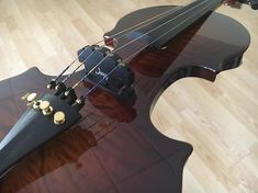 a violin sitting on top of a hard wood floor