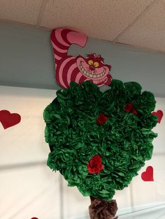 there is a fake tree made out of green paper and red hearts on the wall