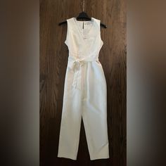 New With Tags! Eternal Ivory Size M Jumpsuit Fully Lined Lace Trim Detail Adjustable/Removable Tie Belt Hook And Eye Closure At Back Straight Cropped Leg Fitted White V-neck Jumpsuits And Rompers, Elegant White V-neck Jumpsuit, White V-neck Pantsuit For Party, White Sleeveless Jumpsuits And Rompers For Formal, White Sleeveless Jumpsuits And Rompers For Formal Occasions, Elegant Cream Jumpsuits And Rompers For Party, White Fitted Jumpsuits And Rompers For Formal Occasions, White Sleeveless Jumpsuit For Formal Occasions, White Fitted Formal Jumpsuits And Rompers