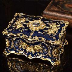 an ornate blue and gold box sitting on top of a table