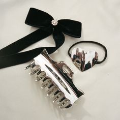 Here to make a statement and add a bit of sophistication to any hair style, this hair tie features a solid metal heart adornment. The interior of the hair tie is lined with extra elastic for an instant ponytail upgrade. Available in 2 shades. Color: Tiara Measurements: 2" x 1 ⅝” Elastic and 100% lead-free metal alloy Jay Heart, Bow Hair Tie, Pinterest Uk, Emi Jay, Holiday Wishlist, Heart Hair, Metal Heart, Wigs Hair Extensions, Hair Tie