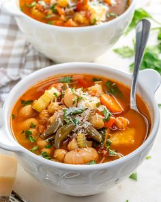 two bowls filled with soup on top of a table