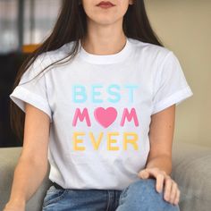 "Best Mum Ever Mothers Day Shirt, Mum TShirts, Mama T Shirt, Best Mum T-Shirt, Favorite Mum Shirts, Mum T Shirt, Shirt For Mum, Mum Shirt Designed by us at Coolnarna, this unique, bespoke \"best mum ever\" t-shirt will make the perfect gift for any lady sun lover out there!   Material: 100% Cotton - 100% Cotton Preshrunk Jersey T-Shirt - Double-Needle Top-Stitched Neckline - Double Stitched Sleeve & Waist Hems - Seamless Collar With Taped Neck & Shoulders - Cap Sleeves For Comfort - Semi-Fitted White Top With Funny Text For Mother's Day, White Tops With Funny Text For Mother's Day, Pre-shrunk White Shirt For Mother's Day, Mother's Day White Shirt With Screen Print, White T-shirt With Custom Print For Mother's Day, White Custom Print T-shirt For Mother's Day, Mother's Day Gift T-shirt With Screen Print, Mother's Day Crew Neck T-shirt With Funny Text, Mother's Day T-shirt With Funny Text And Crew Neck