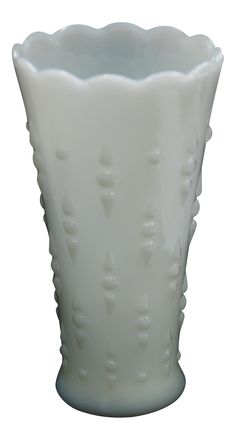 a white vase is shown on a white background with small holes in the bottom and sides