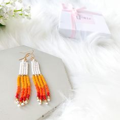 Beautiful White & multicolor hand-beaded earrings. These pairs of rainbow tassel earrings are the perfect earrings for you or for that special gift that you are looking for. They are made with high-quality seed beads and gold-plated ear wires, so if you like them, choose your variation and add click Add to cart and we will prepare them for you. You will receive one pair of earrings available in 2 options: sunset and purple sunset.  Item description:   Materials: -Seed beads in size 11/0 -Gold pl Trendy Beaded Summer Jewelry, Trendy Handmade Summer Jewelry, Trendy Adjustable Jewelry With Dangling Beads, Trendy Summer Jewelry With Matching Earrings, Colorful Beaded Dangle Jewelry Gift, White Handmade Trendy Beaded Earrings, Handmade White Trendy Beaded Earrings, Handmade Trendy White Beaded Earrings, Handmade White Beaded Earrings Trendy Style