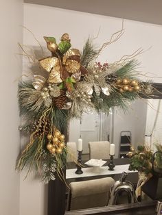 a christmas wreath is hanging on the mirror