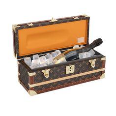 an open suitcase filled with wine bottles and ice cubes