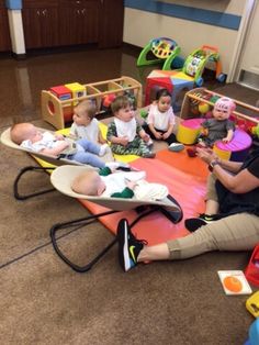 a group of children sitting on top of a play mat