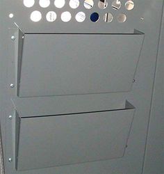 an electrical panel with several holes in it