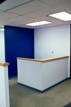 an empty office with blue and white walls