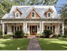 a house with white trim and brown shingles