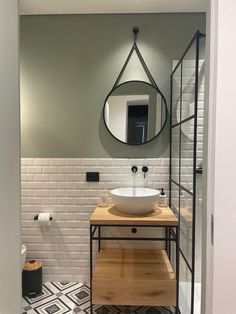 a bathroom with a sink, mirror and tiled floor