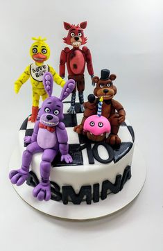 a cake with five cartoon characters on it