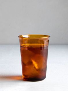 an orange cup sitting on top of a table