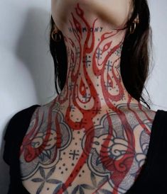 a woman with tattoos on her neck and chest