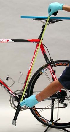 a man is sitting on a bike with his hands on the handlebars and wearing blue gloves