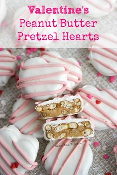 valentine's peanut butter pretzel hearts with pink and white frosting on top