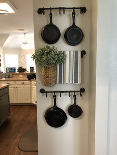 pots and pans are hanging on the wall