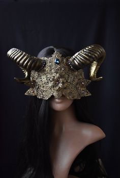 Introducing the "Veil of Shadows," a mesmerizing blind mask that seamlessly merges gothic elegance with a touch of mystique. At the heart of this gothic masterpiece are the imposing horns that rise defiantly from each side of the mask. Blind mask made of metal filigree parts attached to felt. You can see through the ornaments and move around safely. Decorated with metal elements and rhinestones. Metal blind mask attached to the head with a satin ribbon. The mask is available in different colors. (see last photo). The blind mask on the photo in old bronze color. Horned Masquerade Mask, Crown With Horns, Blind Mask, Gogo Dancer Outfits, Veil Mask, Metal Blinds, Metal Horns, Bow Pose, Mask Aesthetic