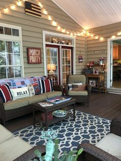 a patio with furniture and lights on the ceiling