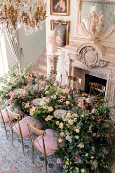 a dining room table covered in flowers and candles