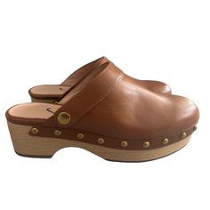 As Seen In Our Fall Campaign... With A Geniune Wood Sole, Traditional Stud Detailing And A Soft Leaather Upper, These Clogs Just Might Be The Only Shoes We Want To Wear Come F Bonus: The Convertible Strap Can Be Worn Two Waysaround The Back Of The Heel For Additional Stability Or Over The Top Of The Foot For Slide-In Ease. Please Note, For The Best Fit We Suggest Ordering One Half Size Larger Than Your Usual Size. Leather Upper And Lining. Wood Sole. Item Ba188. Size: Womens 5.5 Condition: New W Leather Clogs With Branded Insole, Leather Slip-on Clogs With Removable Insole, Leather Slip-on Clogs For Spring, Leather Clogs With Removable Insole And Round Toe, Leather Mules With Branded Insole And Round Toe, Leather Clogs With Removable Insole And Almond Toe, Leather Clogs With Medium Width Leather Footbed, Leather Clogs With Almond Toe And Leather Footbed, Leather Clogs With Branded Insole And Flat Heel