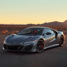 a silver sports car is parked in the desert