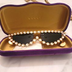 Swarovski Crystal Gucci Cat-Eye Sunglasses Made In Italy Gold Frame, Swarovski Crystals With Pearl Arm End, And Gucci Logo. Excellent Condition No Scratches Comes With An Original Purple Velour Sunglass Case. Cleansing Cloth. Gucci Cat Eye Sunglasses, Crystal Sunglasses, Gucci Logo, Glasses Accessories, Gold Frame, Cat Eye Sunglasses, Swarovski Crystal, Cat Eye, Sunglasses Case