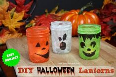 four halloween jars with faces painted on them and pumpkins in the background, all decorated to look like jack - o'- lanterns