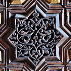 an intricately carved wooden panel in the shape of a star