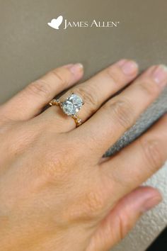 a woman's hand with a diamond ring on it