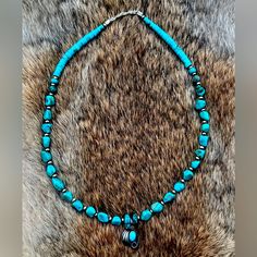 Genuine Turquoise Beads Strung Along Sterling Silver Navajo Pearls With A Handmade Navajo Pendant In The Center. Sterling Silver Clasp And Super Gorgeous Necklace. Stamped Sterling Silver. Let Me Know If You Have Any Questions About This Necklace. Handmade Western Blue Beaded Necklaces, Handmade Blue Western Beaded Necklaces, Handmade Blue Beaded Western Necklace, Western Style Blue Beaded Turquoise Necklace, Blue Western Style Beaded Necklaces, Southwestern Blue Turquoise Necklace With Silver Beads, Southwestern Style Blue Turquoise Necklace With Silver Beads, Blue Turquoise Necklace With Silver Beads Artisan Style, Studio Jewelry