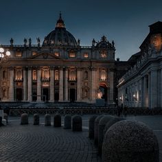 an old building lit up at night with lights on