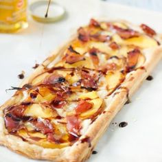 a pizza with toppings sitting on top of a table