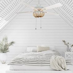 a bedroom with white walls and ceiling fan in the middle of it, along with a bed