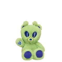 a small green teddy bear with blue eyes