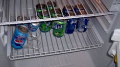 an open refrigerator filled with lots of soda