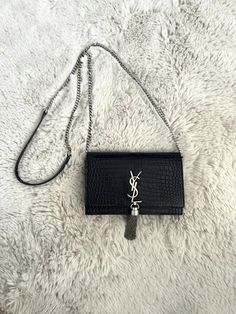 100% Authentic YSL Kate Wallet On Chain Bag With Tassel & Silver Hardware Crocodile embossed with tassel and silver hardware. Bag is pre-owned. Exterior leather has light signs of use, a bit of creasing which is normal and corners are in good condition as shown in images. Interior is clean, but has some scratching in the leather and marks/ staining from makeup that was in the purse (such as lip liner). This also includes the interior zipper pocket. Chain is detachable and clasps function properly. Tassel is firmly attached. Please view images in DETAIL and ask any questions PRIOR to purchasing!! ** This bag is absolutely, under no circumstances, returnable or refundable, I have been scammed too many times and will not be allowing returns. ** Bag is shipped with USPS Priority Mail. Bag come Ysl Kate, Chain Bags, Lip Liner, Zipper Pocket, Bag Sale, Bags Handbags, Tassels, Dust Bag, Bag Lady