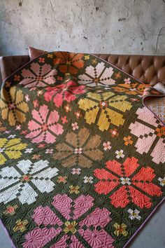 a couch with a quilt on top of it