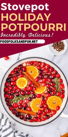 a pot filled with cranberries and oranges on top of a white counter