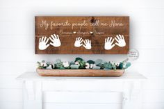 a wooden sign that says, if favorite people call me mama and three hand prints on it