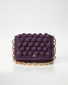 - 100% Handmade - Plum colour - Measurements L:29cm x H:19cm x W:10cm - Metallic gold chain, 70cm long - Crochet flap with magnetic closure - Lined fabric interior for protection and durability - Comes with a dust bag to always keep your Miss Polyplexi bag well-protected and clean The Ossian Bag is an iconic design of Miss Polyplexi, introduced in this beautiful plum colour to instantly transform you into a style icon all year round. With a structured silhouette, this handbag can hold all your d Wedding Guest Bag, Wedding Guest Bags, Plum Colour, Crochet Crossbody Bag, Crochet Shoulder Bag, Bubble Bag, Evening Handbag, Bag Collection, Bag Luxury